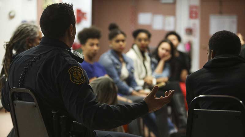 Pittsburgh police officers talk with Pittsburgh-area teenagers about how they can maintain peace and mutual respect during their interactions.