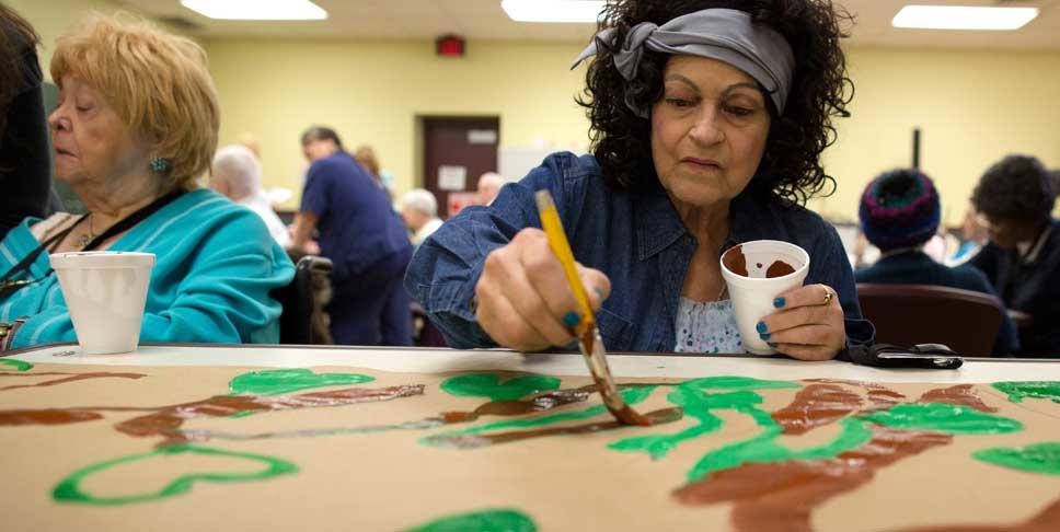 Rose Marie Harris, right, paints leaves on a mural at Community Life of McKeesport through the nonprofit Fine Art Miracles, Inc, which was founded by Tess Lojacono to bring fine art to nursing homes and assisted living facilities. In 2012, Lojacono was awarded $100,000 as part of the Expereinced Dreamers contest to raise awareness of the region as a great place to live, work and realize your dreams, regardless of age.