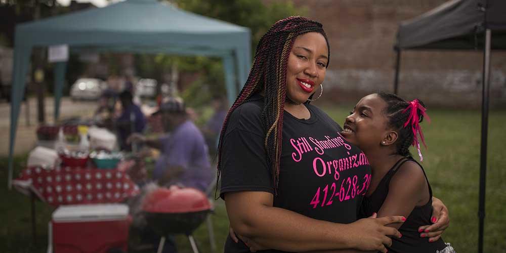 Elise M. McClung and her daughter, Anasjae, now 11, at Grillin’ for a Cause, a fundraising cookout Elise organized for the Black and White Ball, which benefits families with emergency and ongoing needs. McClung is a single woman raising a child — a demographic category with about 30,000 members in Allegheny County and is a focus of our organizing principle, 100 Percent Pittsburgh.